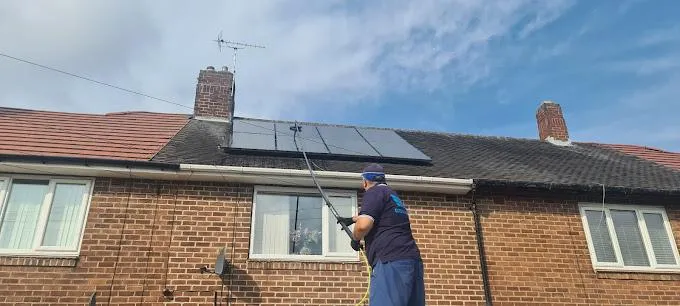 team member cleaning solar panels 