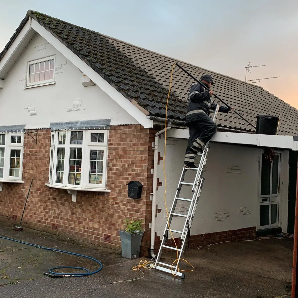 Image of team member cleaning a roof 