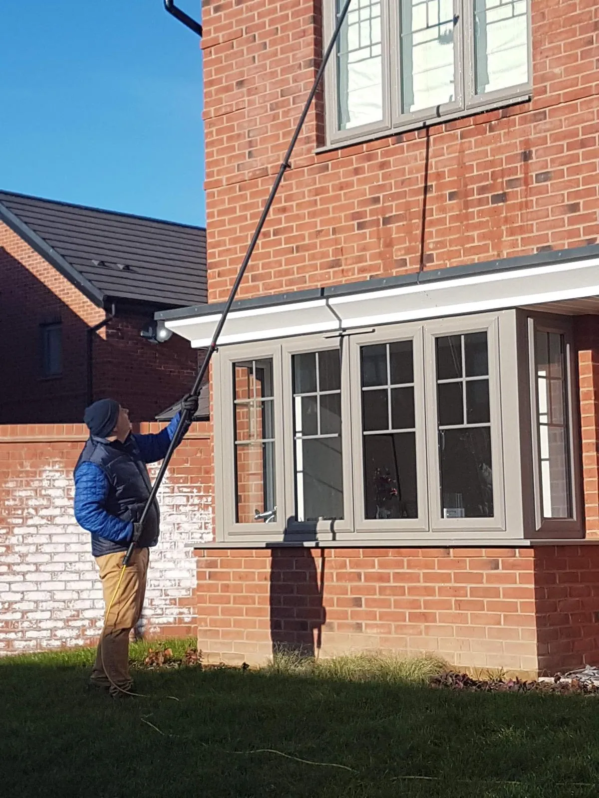 Team member cleaning windows 