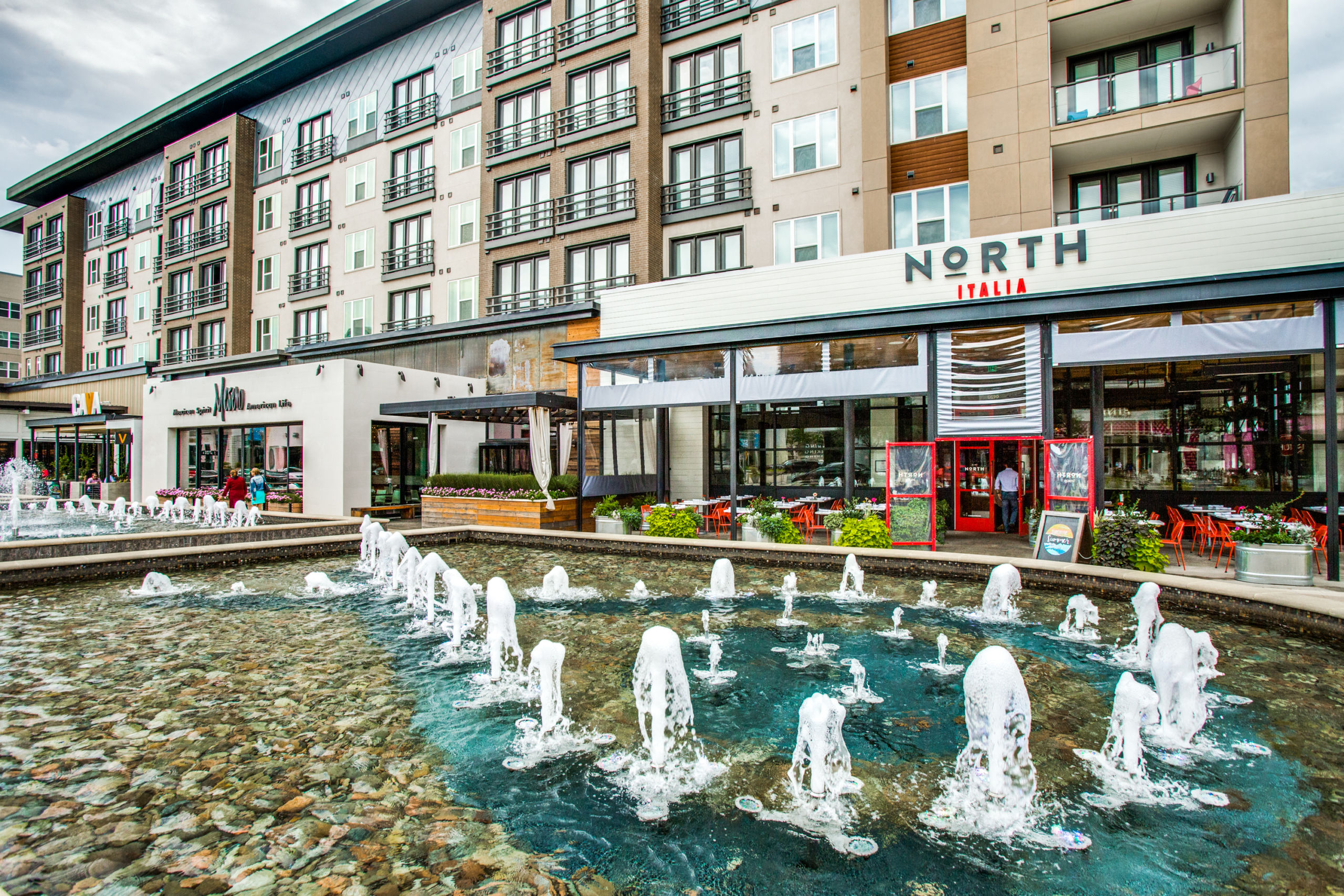 Legacy West in Plano, Texas with modern shops and urban architecture in a soft blur.