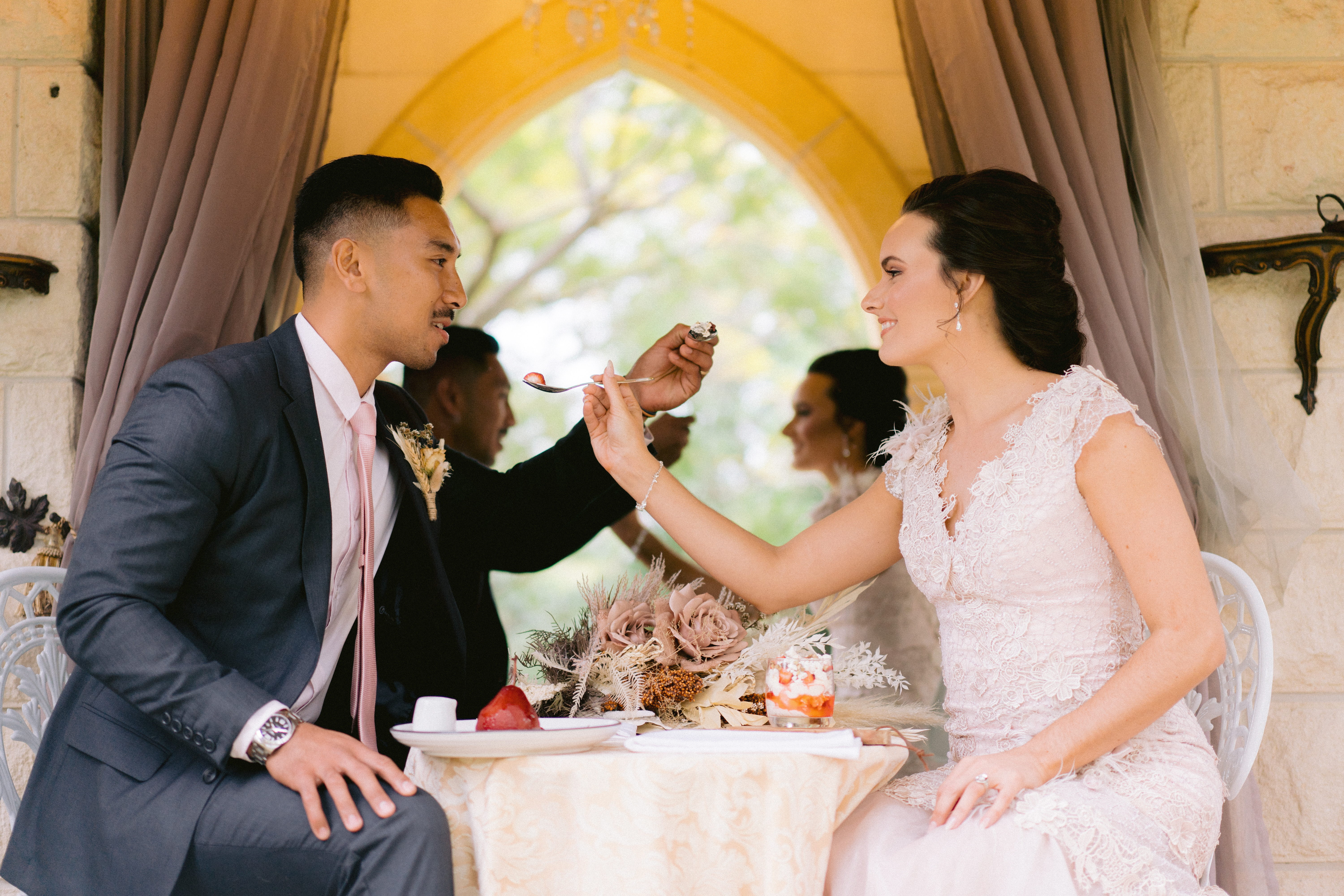 Couple sharing a bite at their wedding