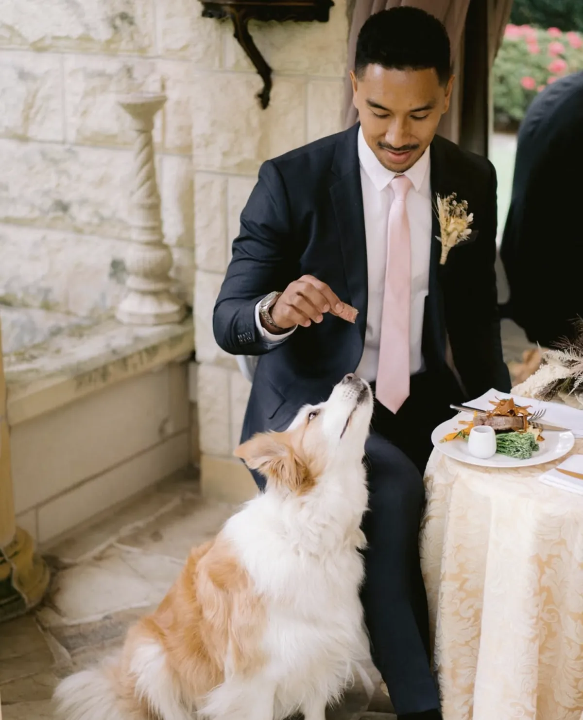 Groom relaxing with his dog at the table