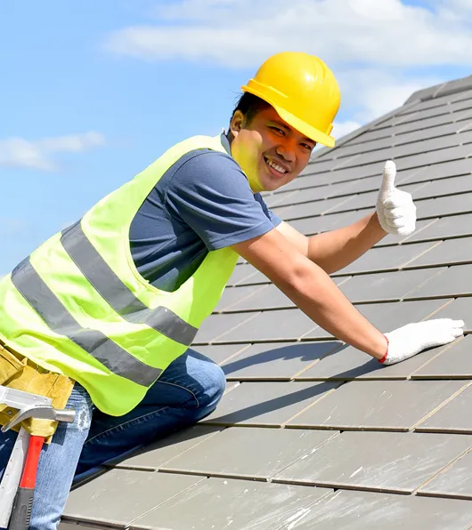 Roofer on roof of newly completed poject