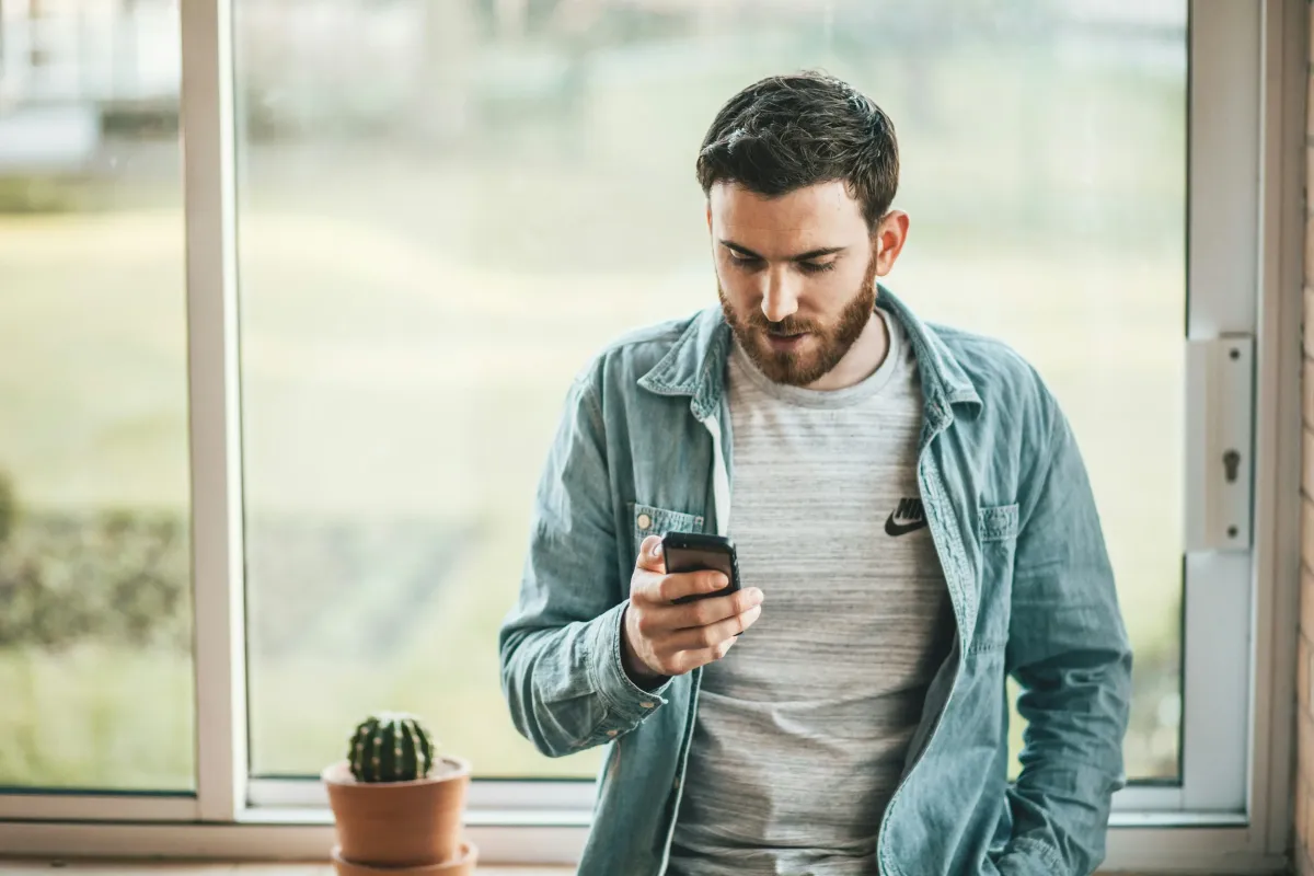 Image of a Young Man looking a his Phone