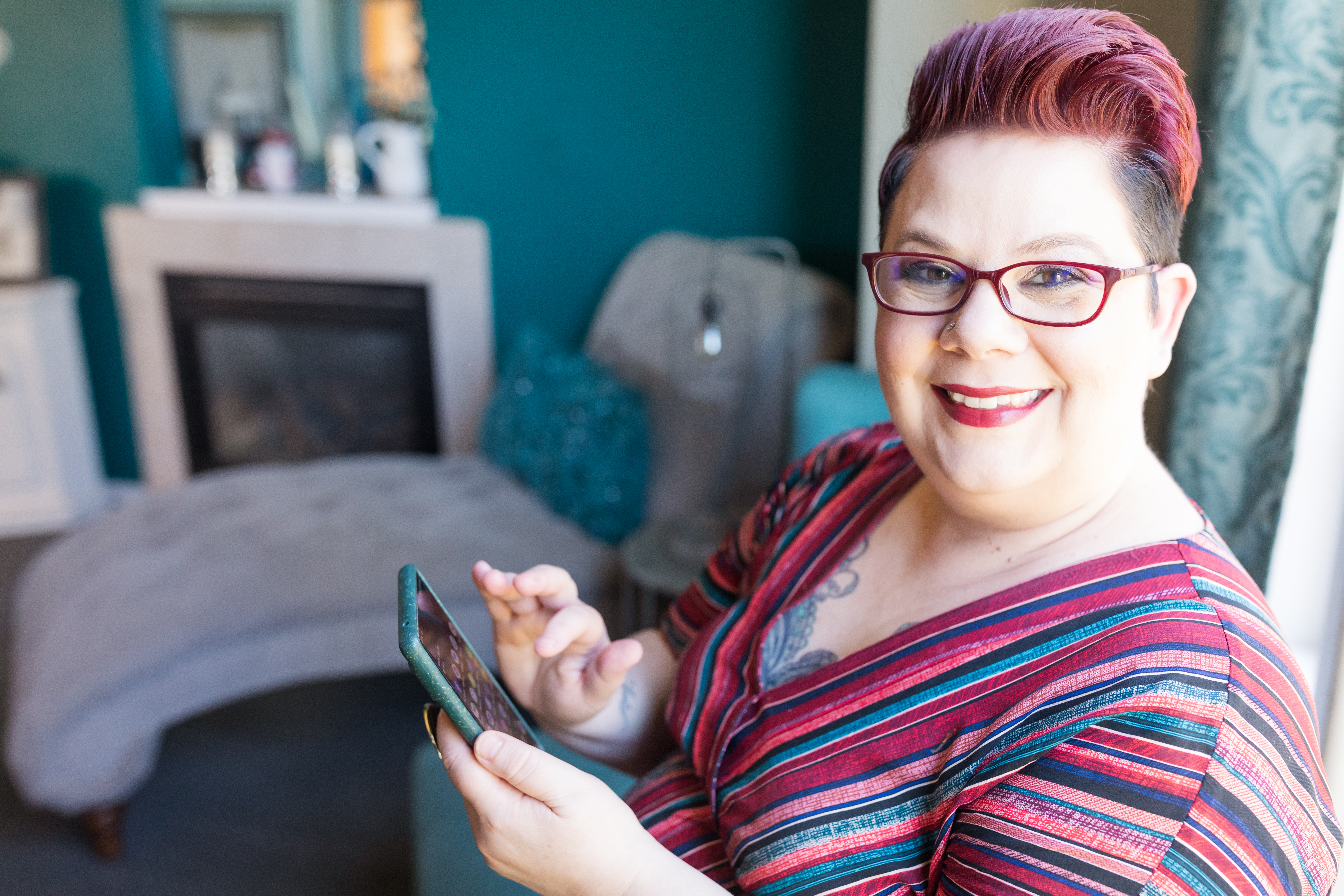 Elaine Turso on cell phone smiling at camera