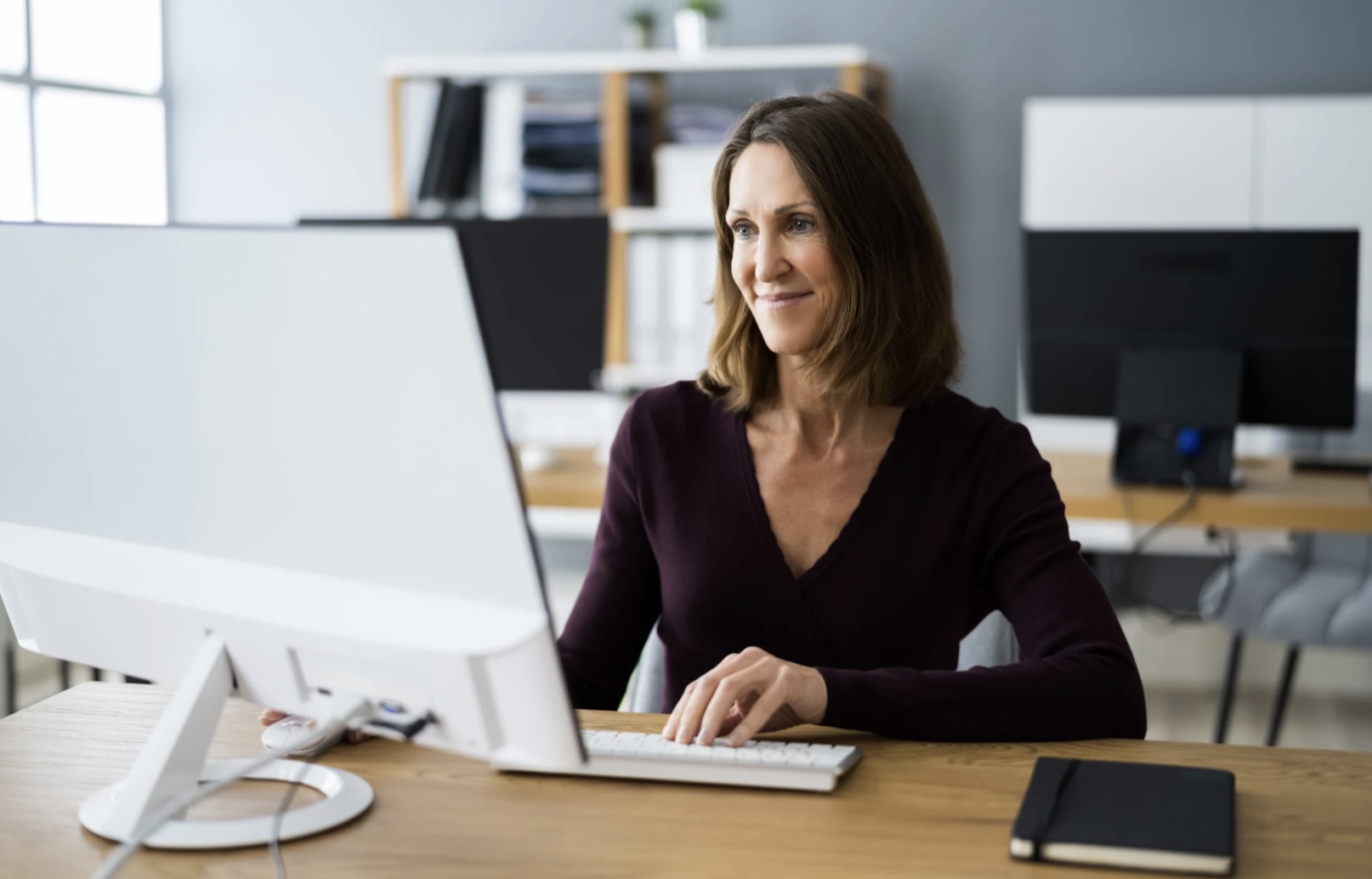 A senior male CEO in a sleek boardroom, analyzing a printed leadership diagnostic report with annotated charts. The environment is calm, with natural light and minimalist decor, highlighting focus and professionalism. 3:2 aspect ratio.