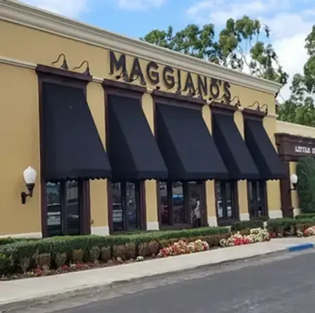 Commercial black fixed window awnings installed on a restaurant storefront in Costa Mesa, CA