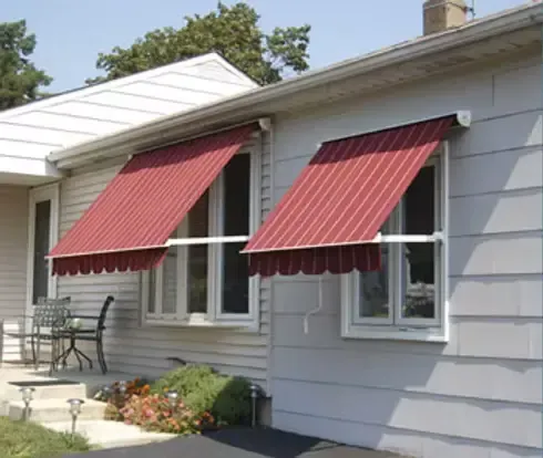 Red striped retractable window awnings installed on a residential home in Fullerton, CA