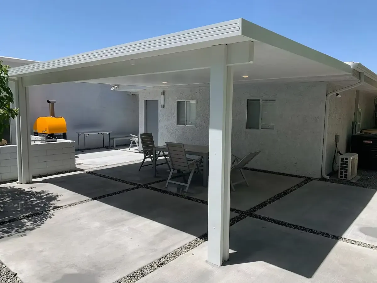 White solid patio cover shading an outdoor dining area on a residential concrete patio in Buena Park, CA