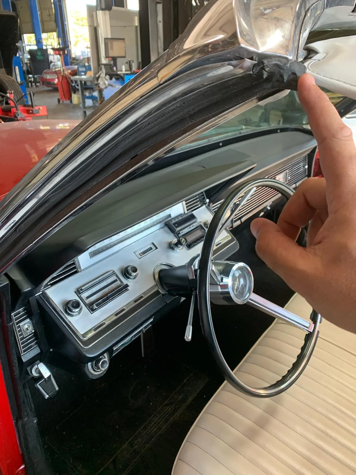 a person sitting in a chair in a large room with glass walls