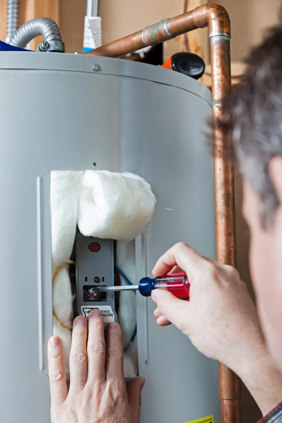 a person fixing a heating unit