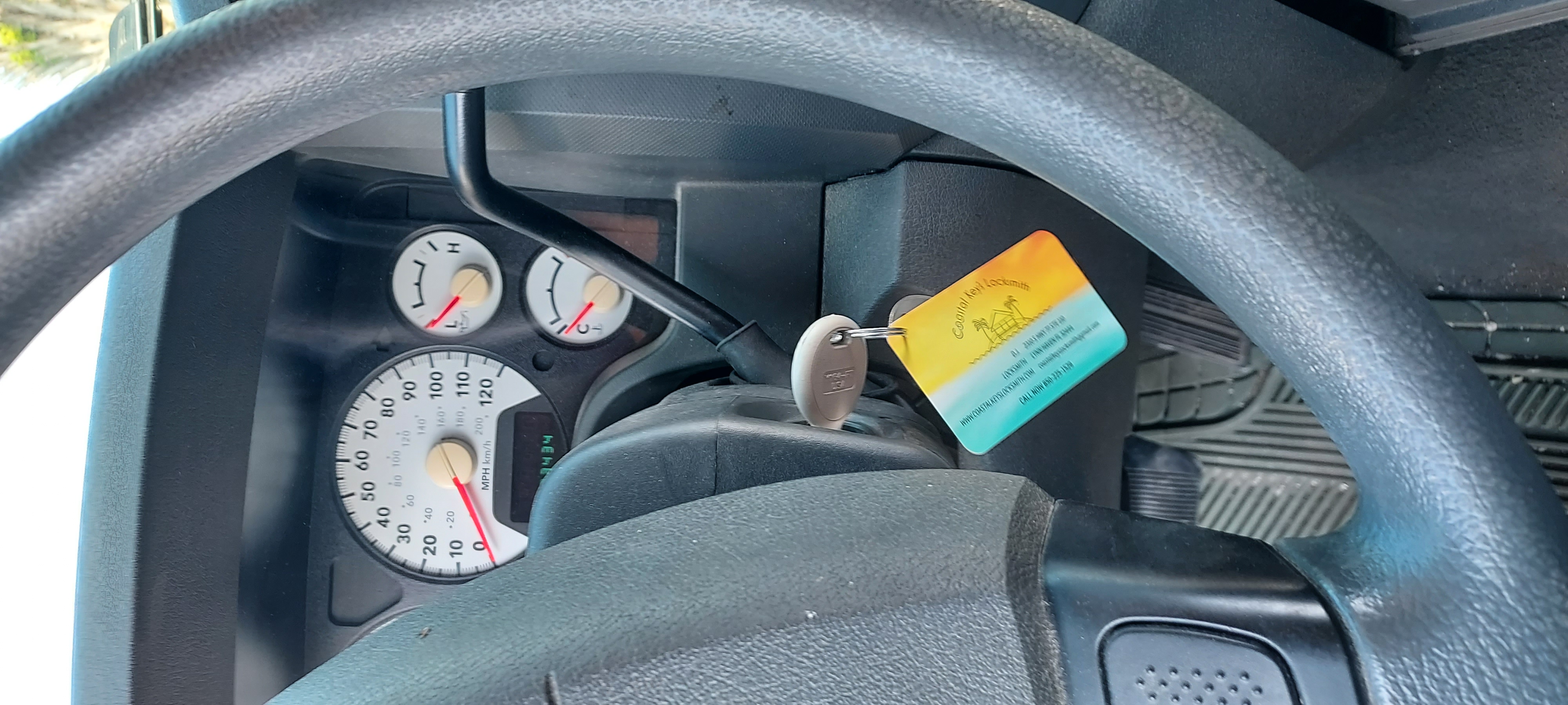 Coastal Keys Locksmith team of three diverse technicians standing in front of their branded van, smiling and ready to help. The background shows palm trees and a sunny Florida street.
