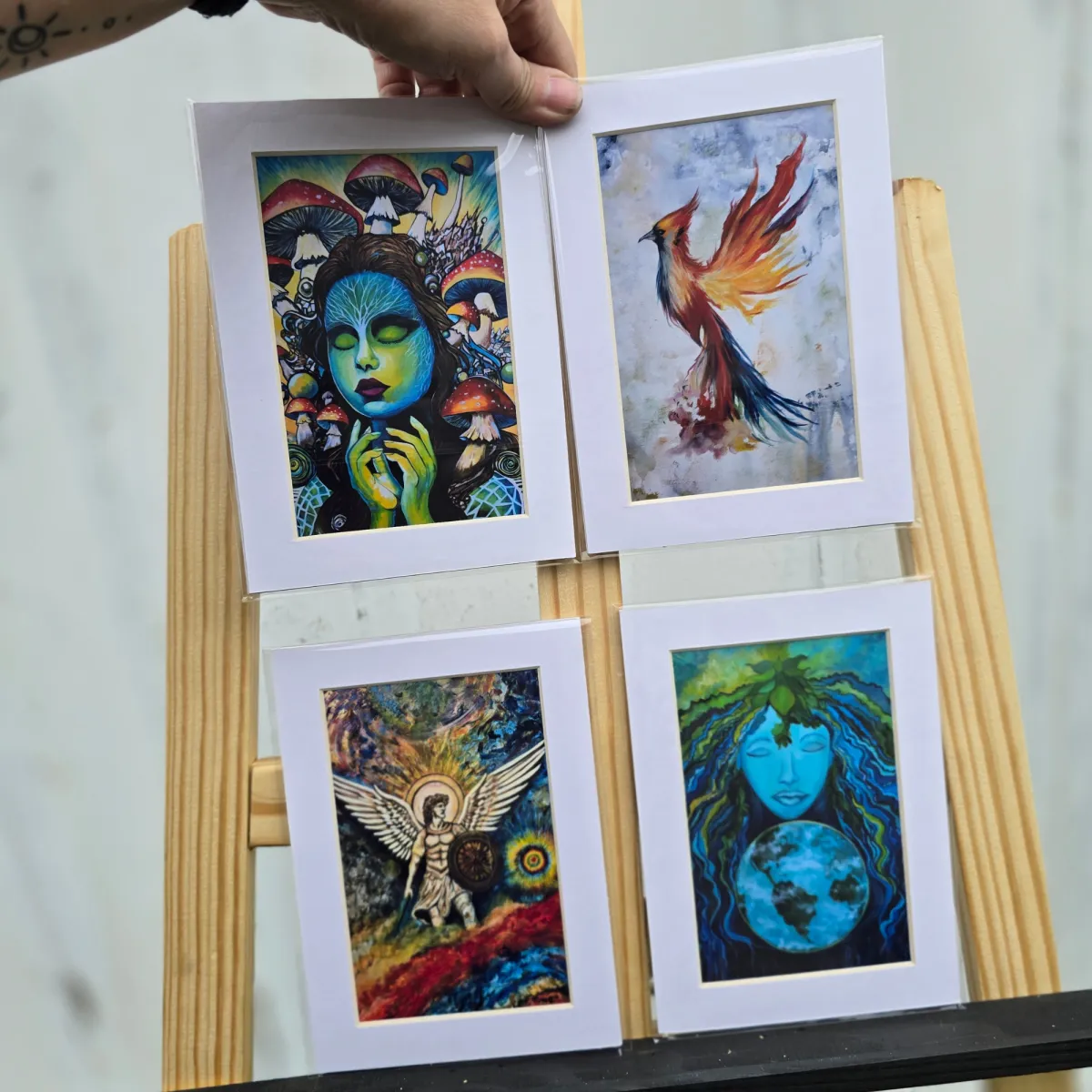 Botanical and mystical themed 5x7 art prints layered on a royal purple background