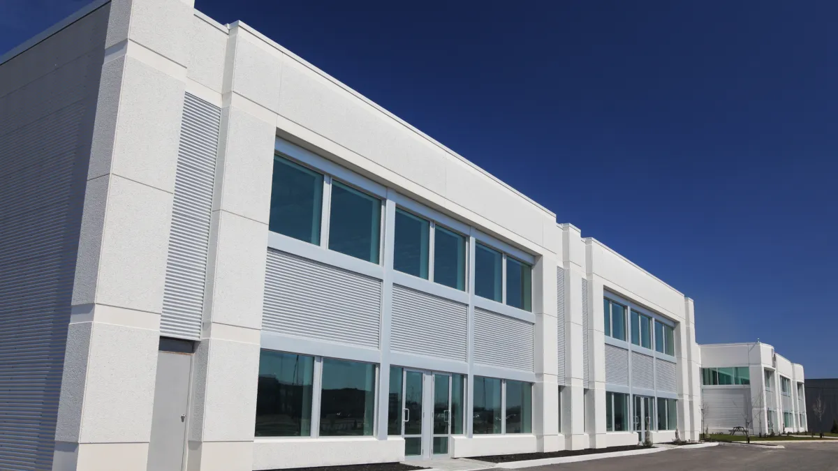 Freshly painted white commercial building showcasing clean and uniform exterior finish
