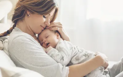 Mother holding a newborn baby after IVF on her chest.
