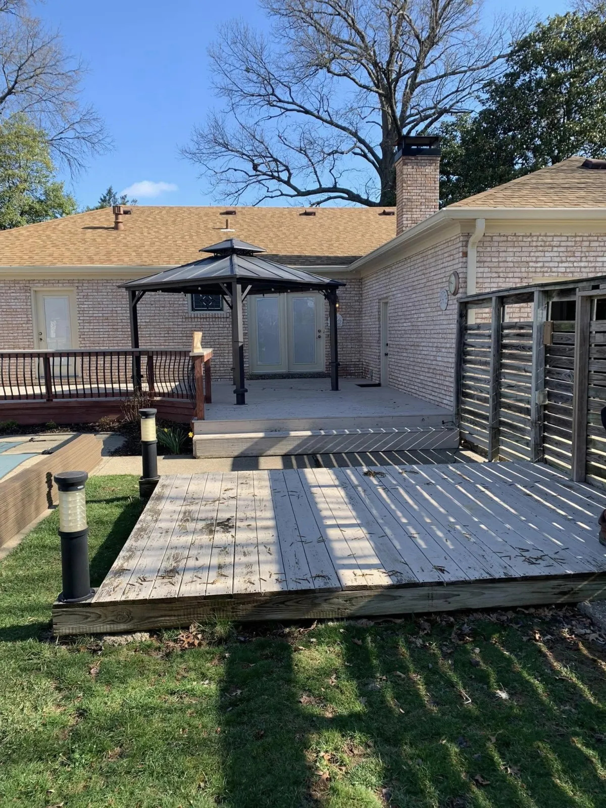 a wooden fence with a blue striped wall behind it