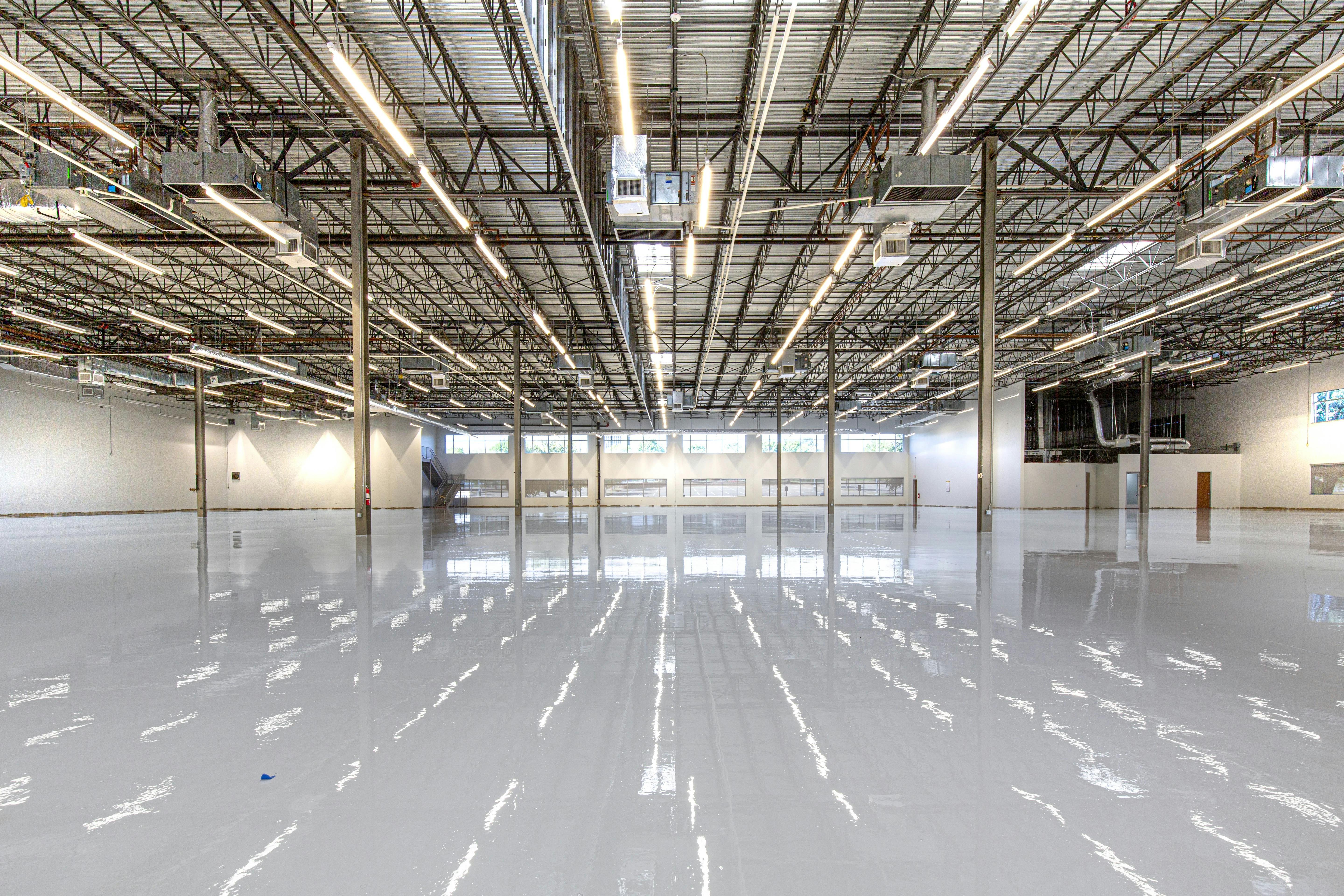 open, empty warehouse with white epoxy floor