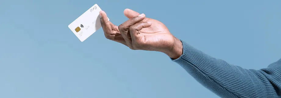A hand holding a credit card