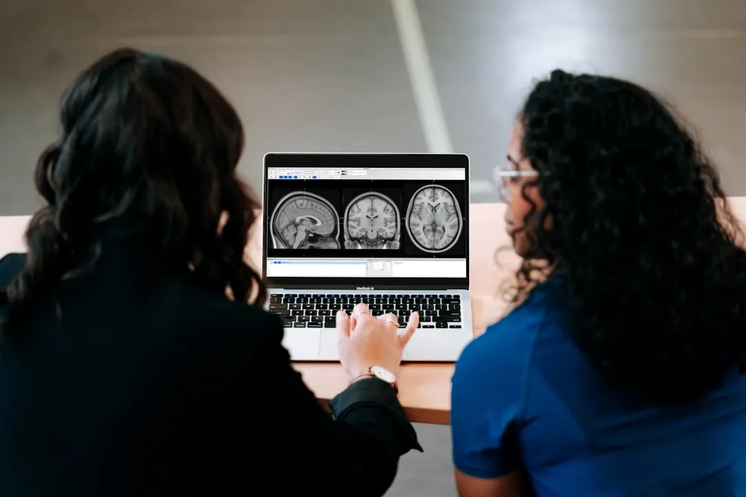 A healthcare professional reviewing a 3D brain model with a patient