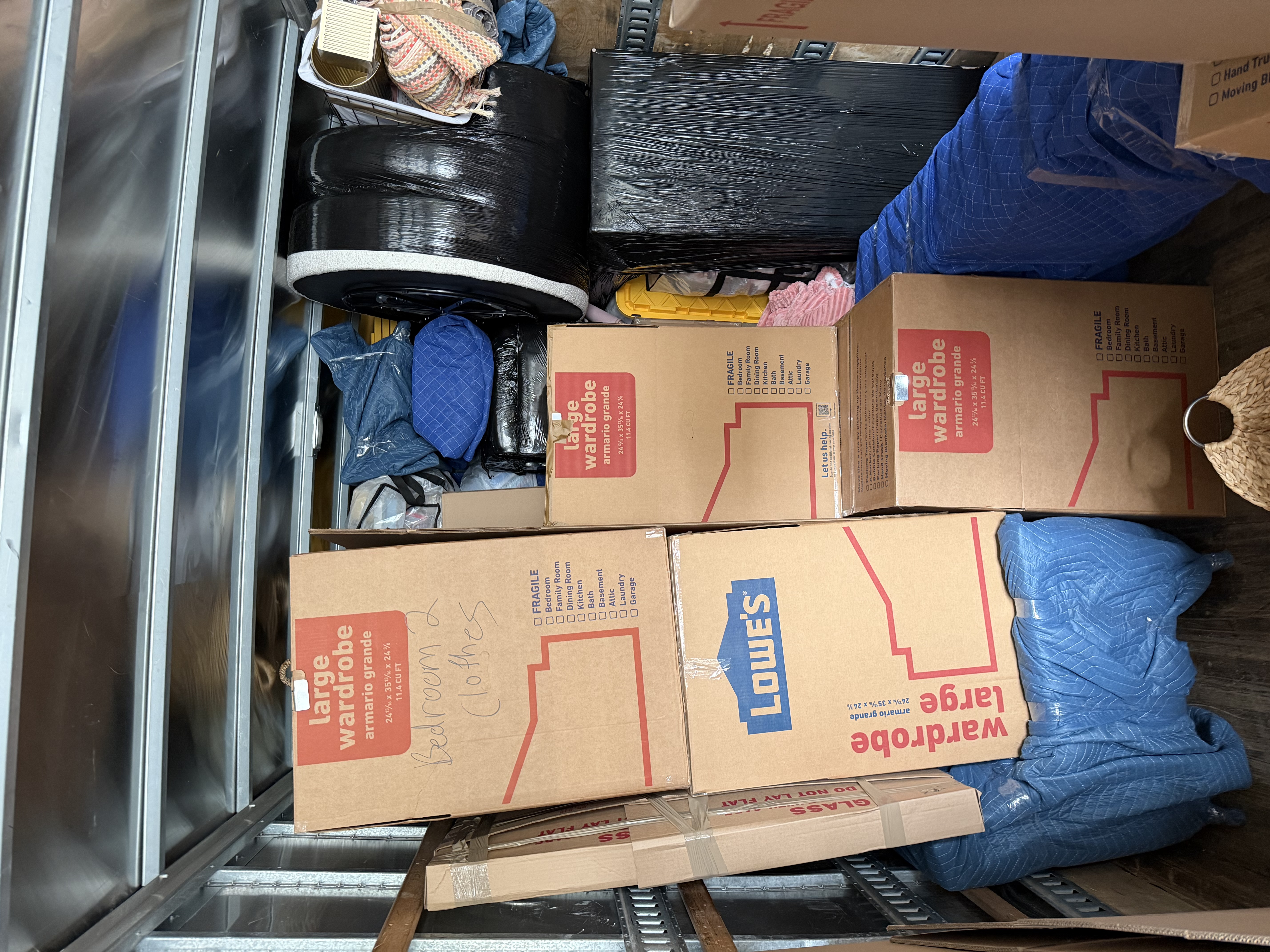 Packed moving trailer filled with boxes, bags, and various household items, illustrating the packing process for Keep It Moving Services NJ.