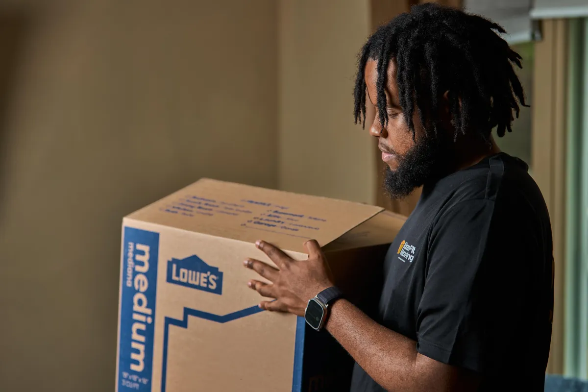 Professional movers holding box