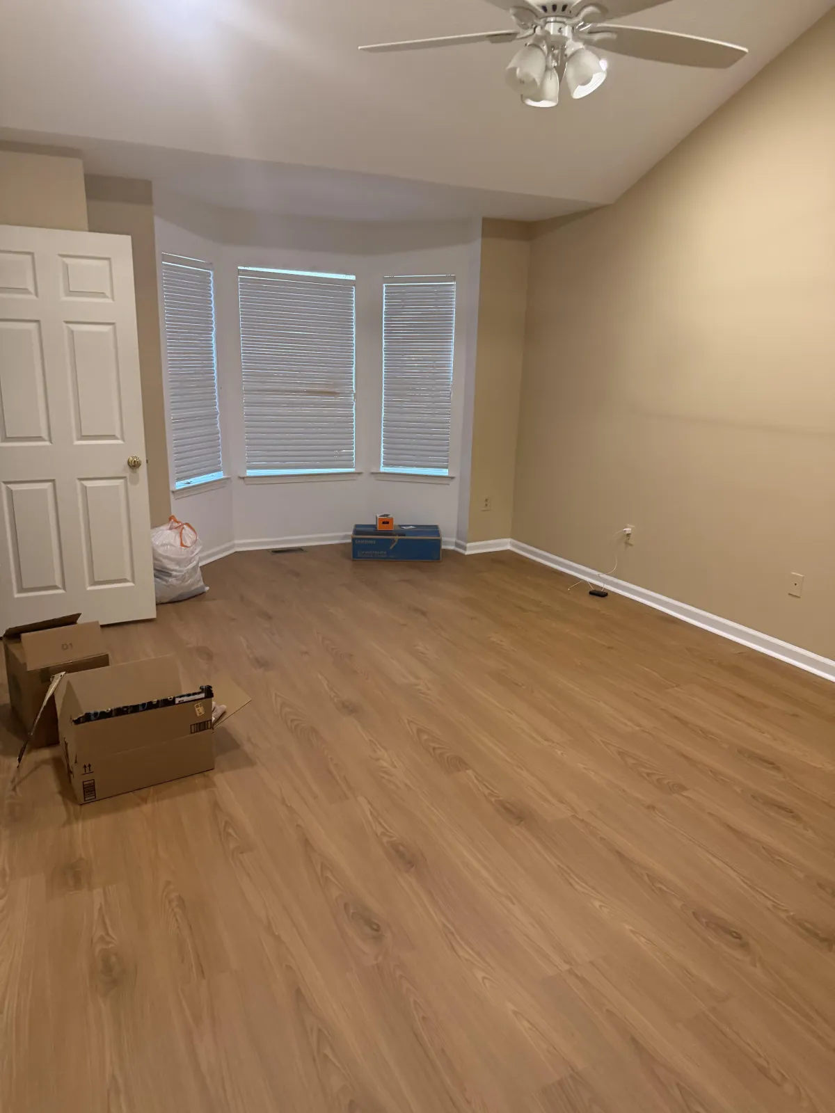 Two smiling men giving thumbs up inside a storage unit, representing teamwork and readiness in moving services.