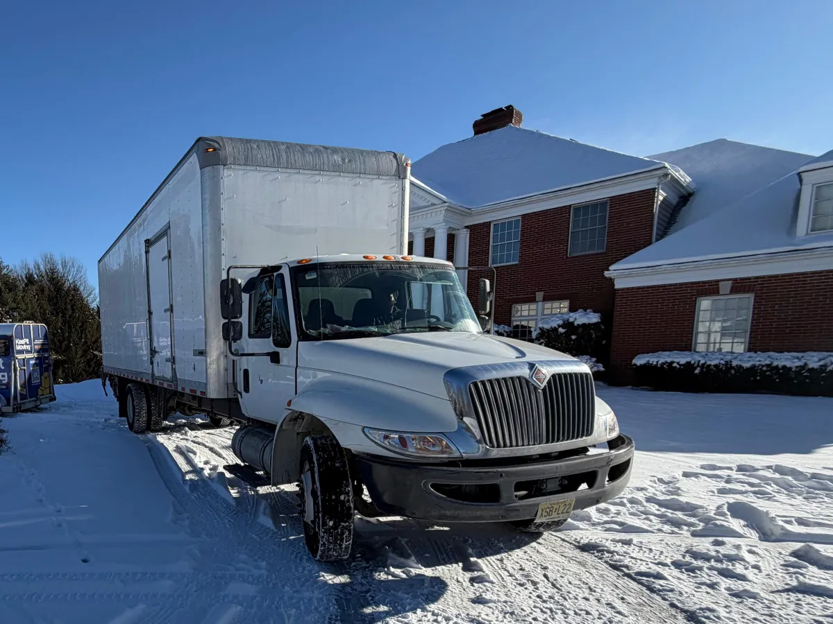 Keep It Moving Services box truck parked at a residential property during a dedicated long-distance move from New Jersey.