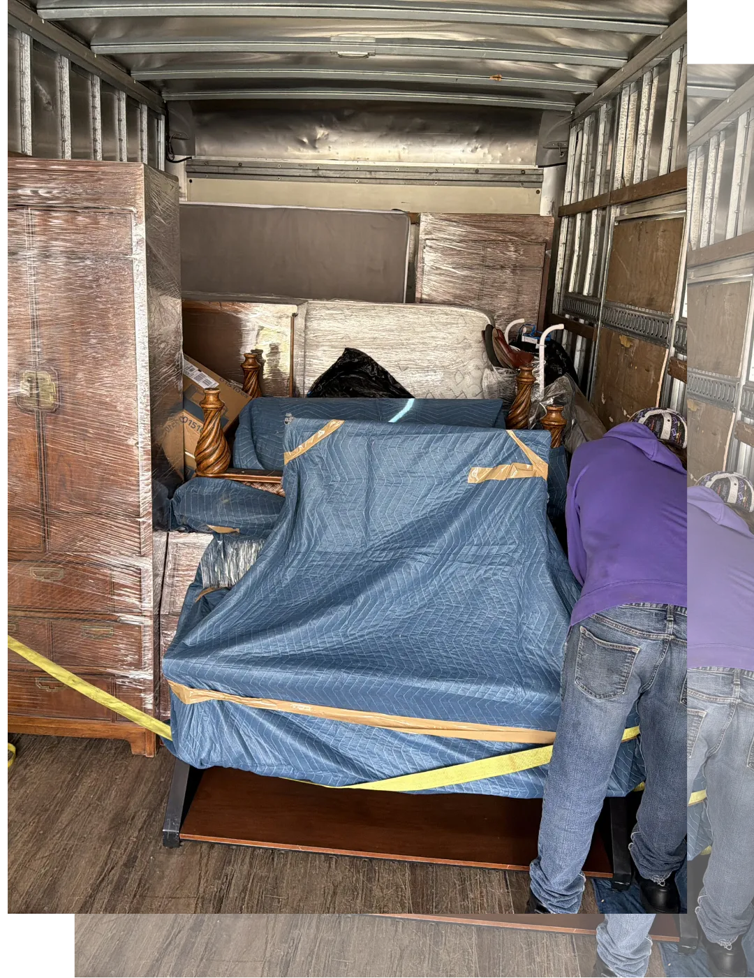 Furniture wrapped in moving blankets and securely strapped inside a truck for a local residential move in New Jersey.