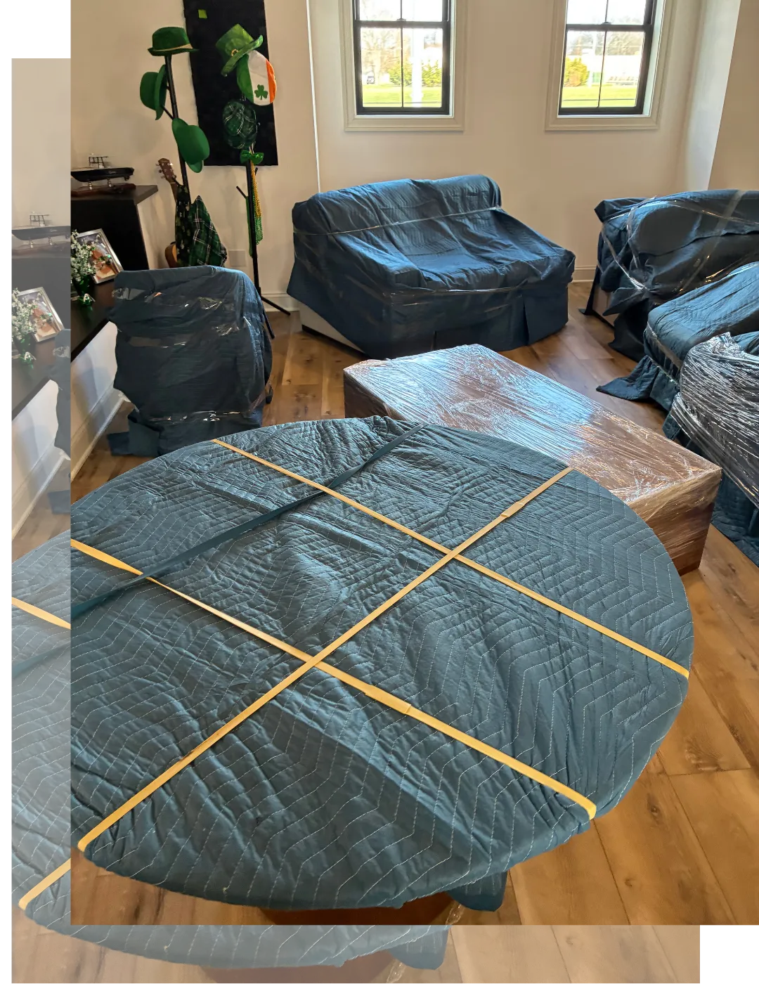 Household furniture professionally wrapped with moving blankets and protective materials inside a home, prepared for safe transport during a residential move in New Jersey.