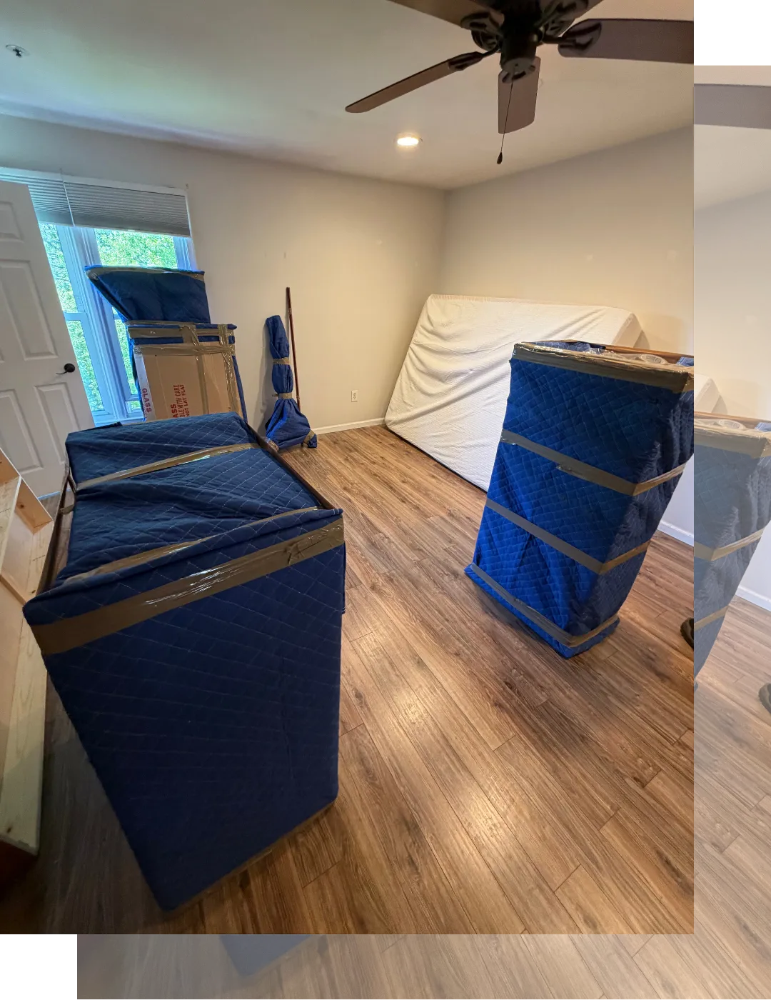 Furniture wrapped in moving blankets and securely strapped inside a truck for a local residential move in New Jersey.