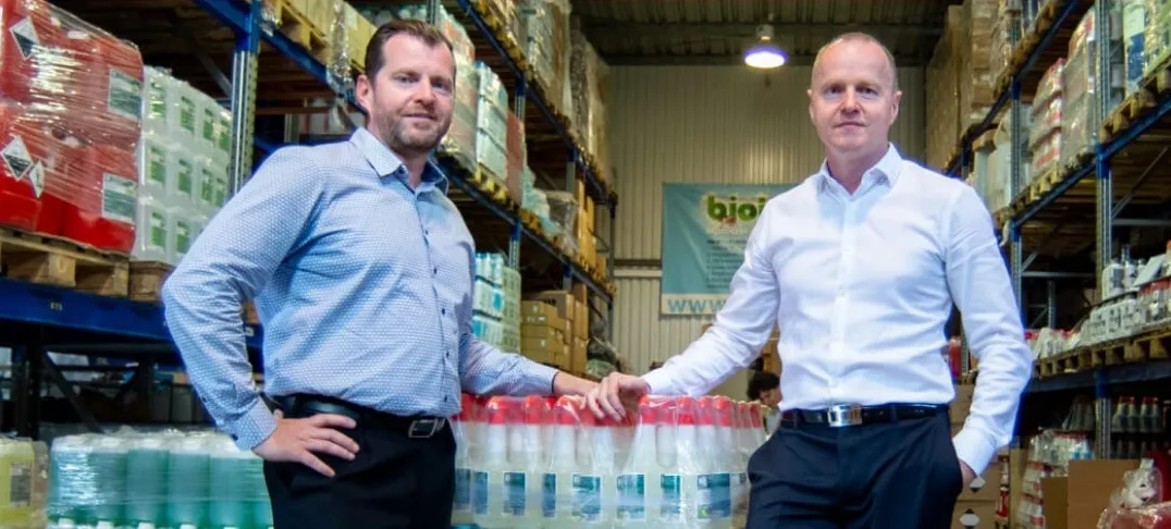 Brilliance partner receiving award at international expo, diverse audience, branded stage, celebratory atmosphere, business attire, 3:2 aspect ratio