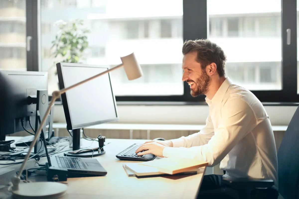 man typing on computer at work