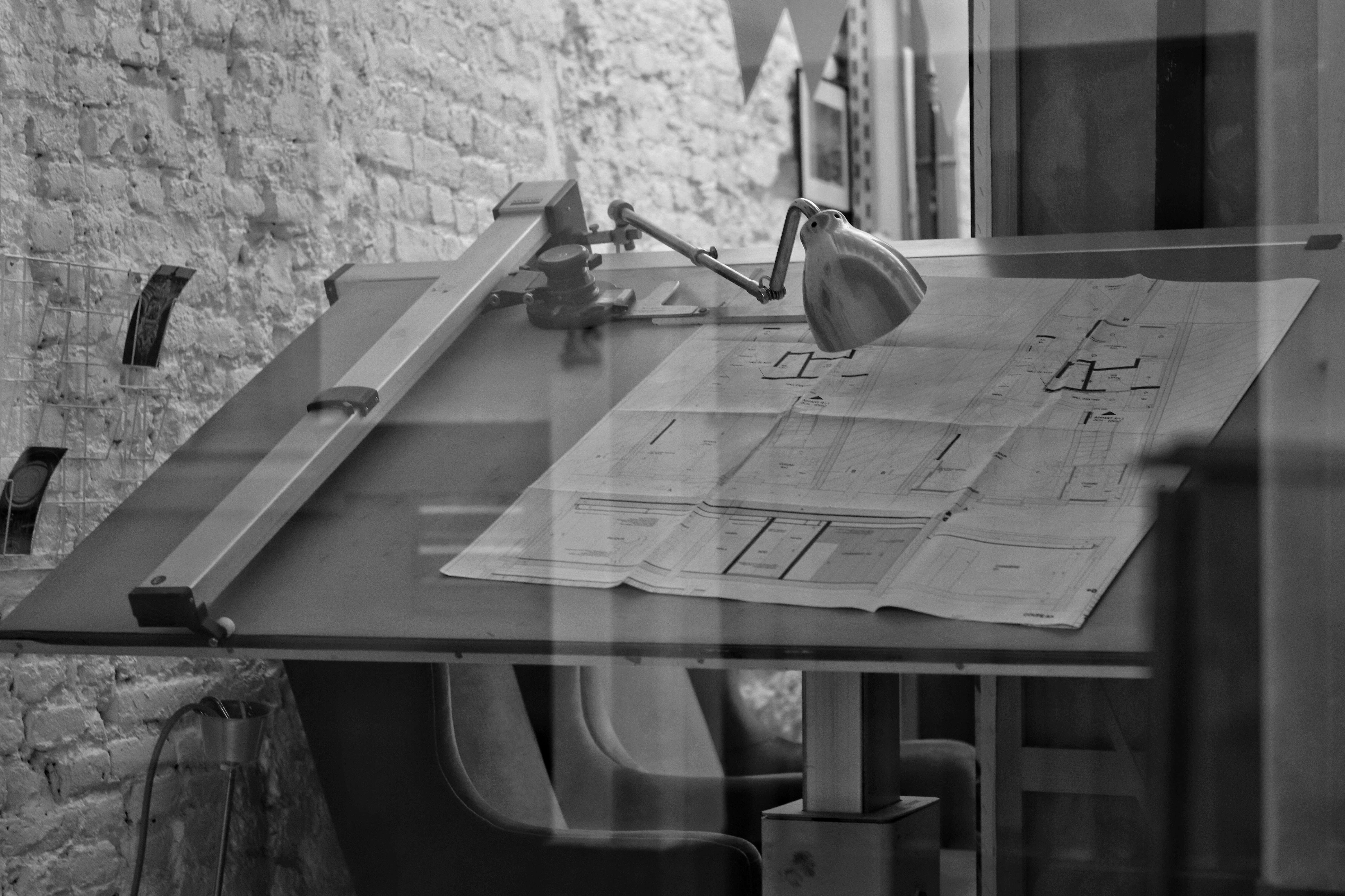Architect drafting table with blueprints representing SEO strategy foundation for architecture firms