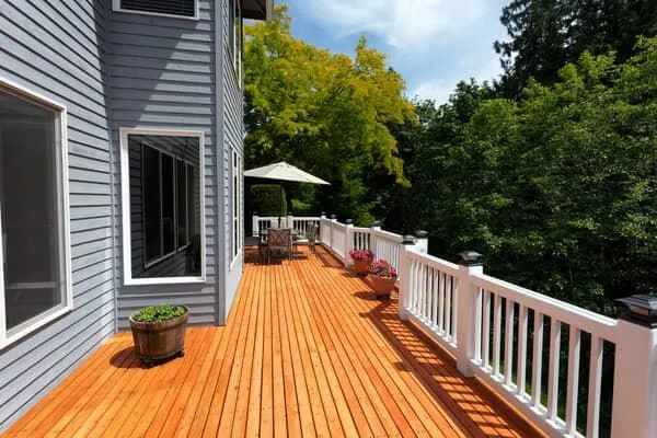 Custom wood deck installation with white railings