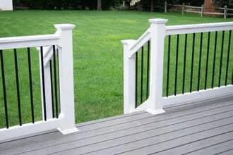 White wood handrails on composite deck with black spindles