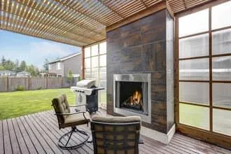 Covered deck with composite flooring and fireplace feature