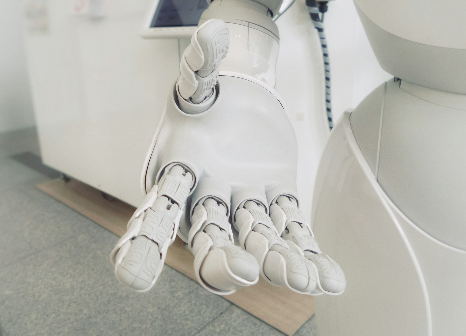 White robot hand reaching forward, symbolizing automated trading
