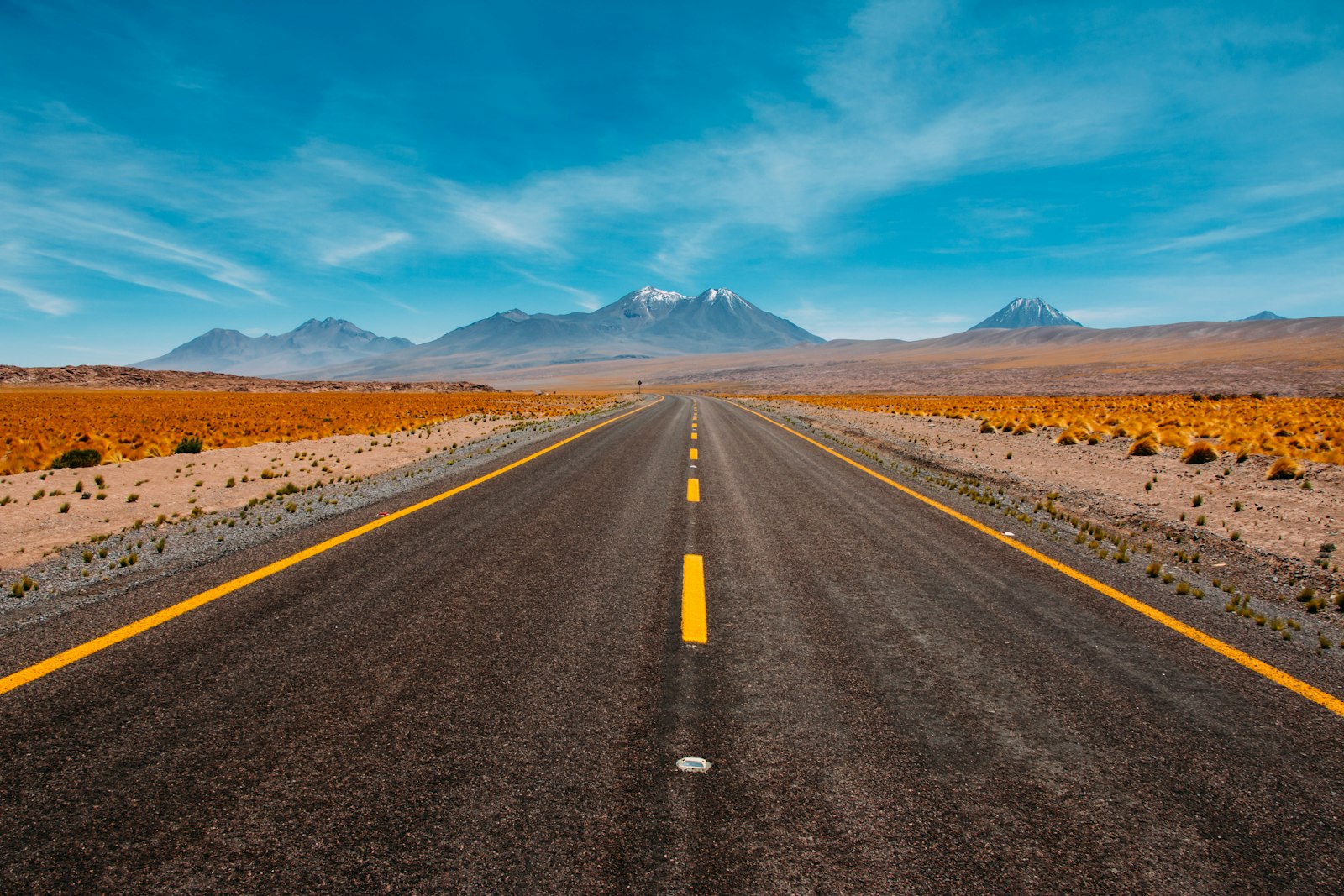 Long straight road stretching toward distant mountains