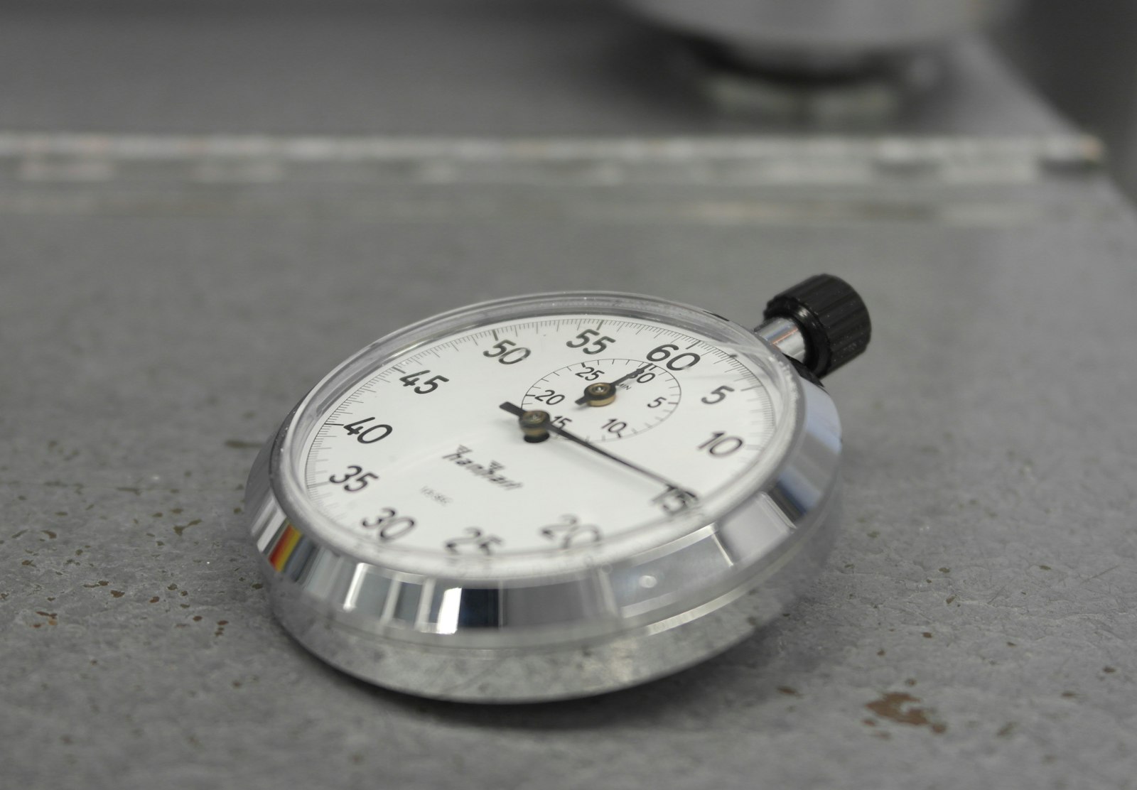 Analog stopwatch on a metal surface — the 30-day evaluation clock