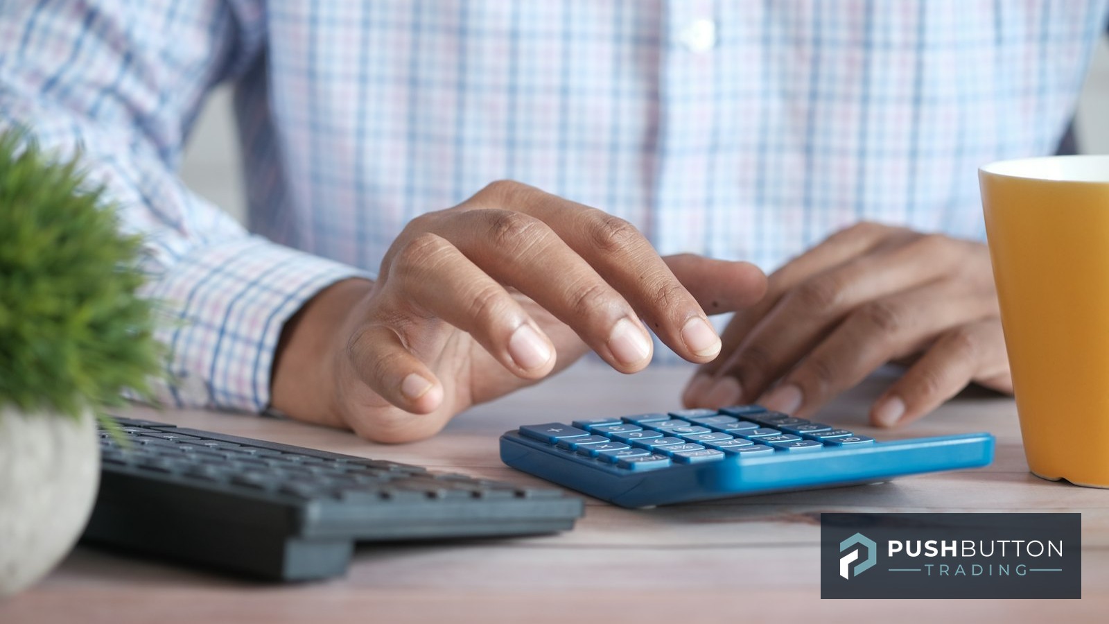 Trader working position sizing numbers on a calculator at a desk