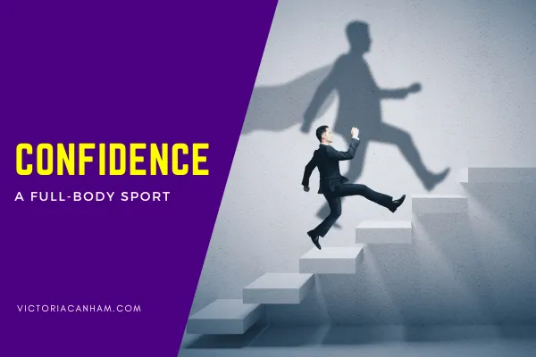 A businessman in a suit confidently strides up a series of white steps, his shadow on the textured grey wall behind him depicting a superhero in a cape leaping upwards. The words "CONFIDENCE" in bold yellow and "A FULL-BODY SPORT" in smaller white text appear on a purple background to the left. The website victoria https://www.google.com/search?q=canham.com is visible at the bottom left.