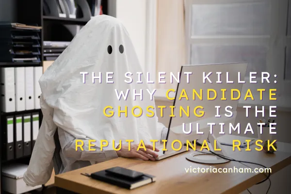 Victoria Canham Consultancy |  A person covered by a white sheet with black ghost eyes sits at an office desk, using a desktop computer. The image is overlaid with the title: "The Silent Killer: Why Candidate Ghosting is the Ultimate Reputational Risk." This visually represents the act of candidate ghosting in recruitment.
