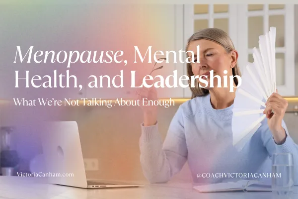 Victoria Canham Consultancy |  Woman experiencing a hot flush at her laptop, holding a fan. Blog title "Menopause, Mental Health, and Leadership" and Victoria Canham branding are overlaid.