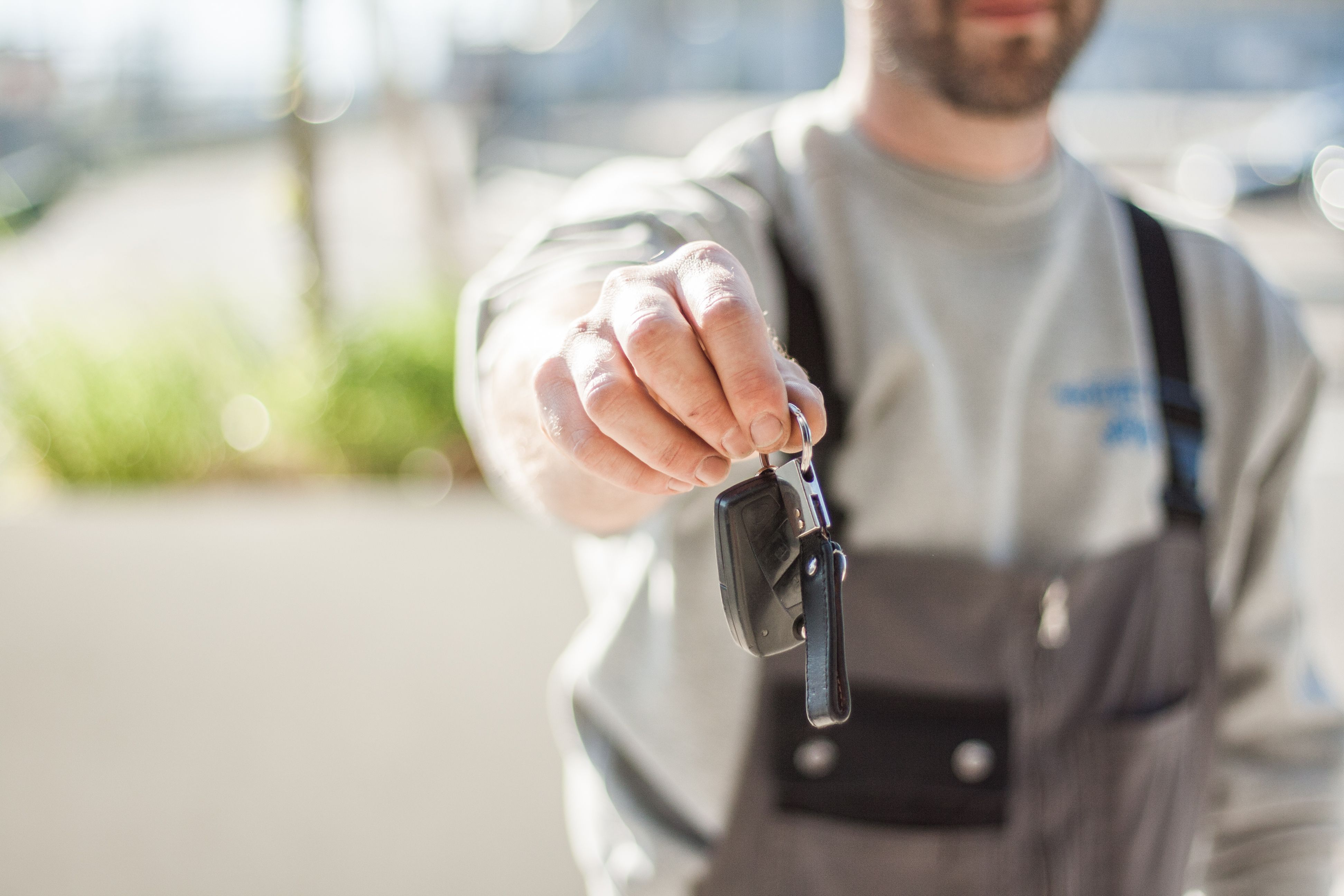 Locksmith handing a replacement car key in North Port, FL