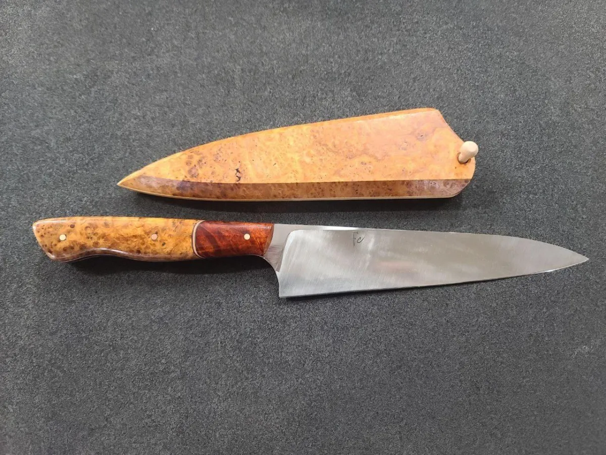 handmade 190mm Western Chef's knife combines a robust 52100 steel blade with a luxurious handle made from Golden Amboyna burl and Red Logwood, accented with copper spacers