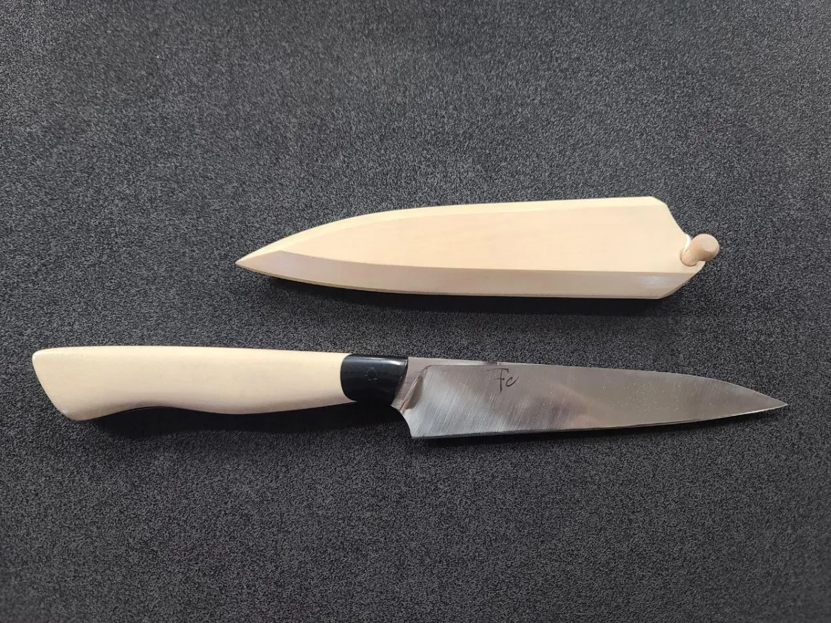 handcrafted 140mm Petty knife features a razor-sharp 52100 steel blade paired with a stunning American Holly and Micarta handle