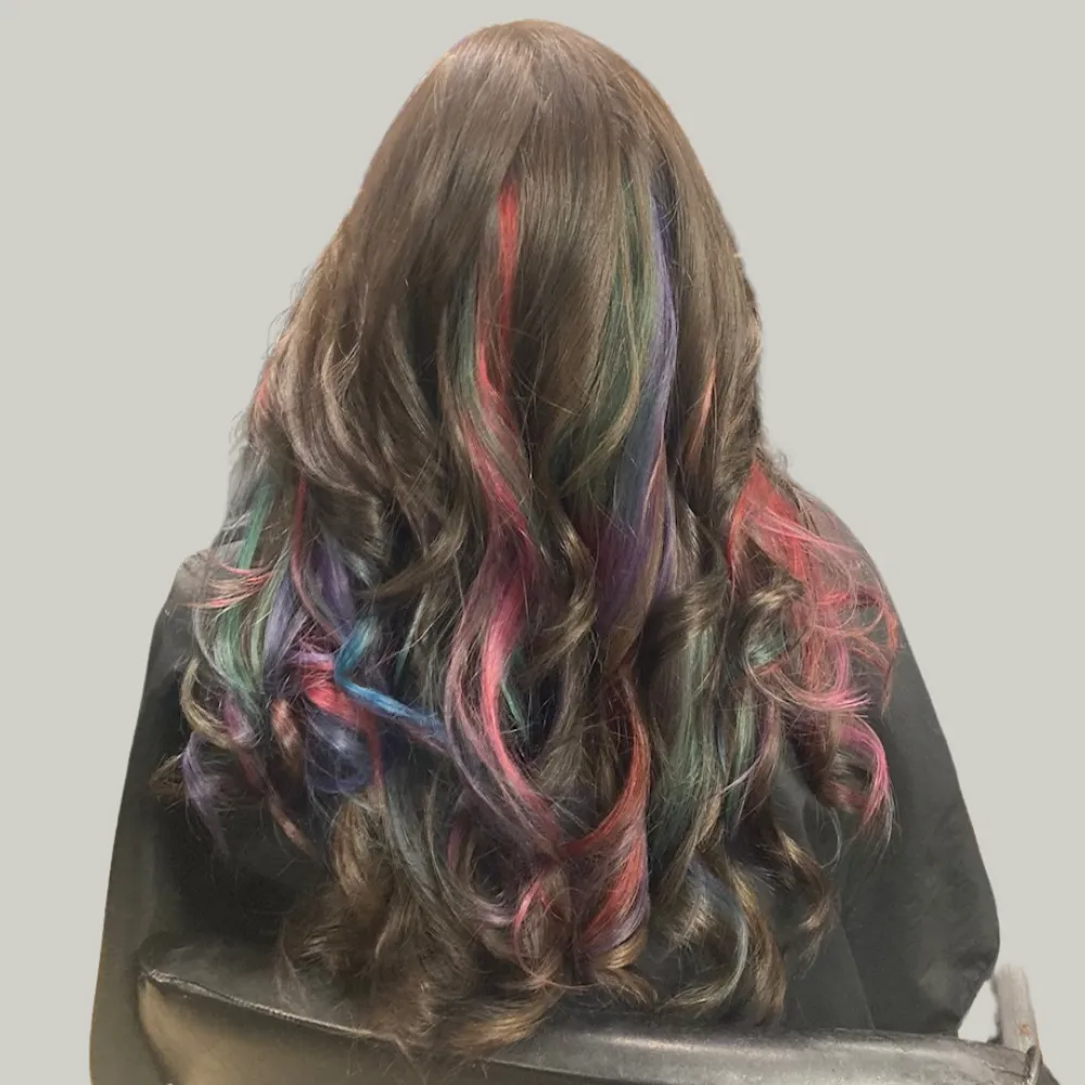 Vibrant pinks, blues and greens on medium to long curly hair
