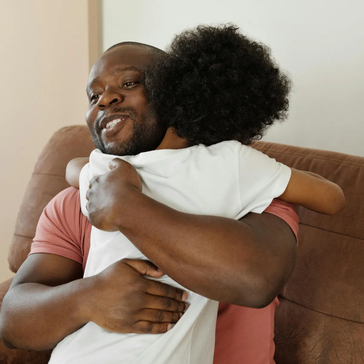 Father hugging is son for success at school