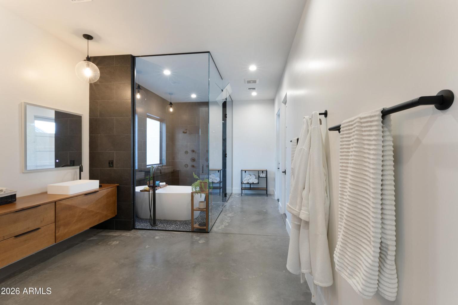 bathroom with large bathtub and glass shower 