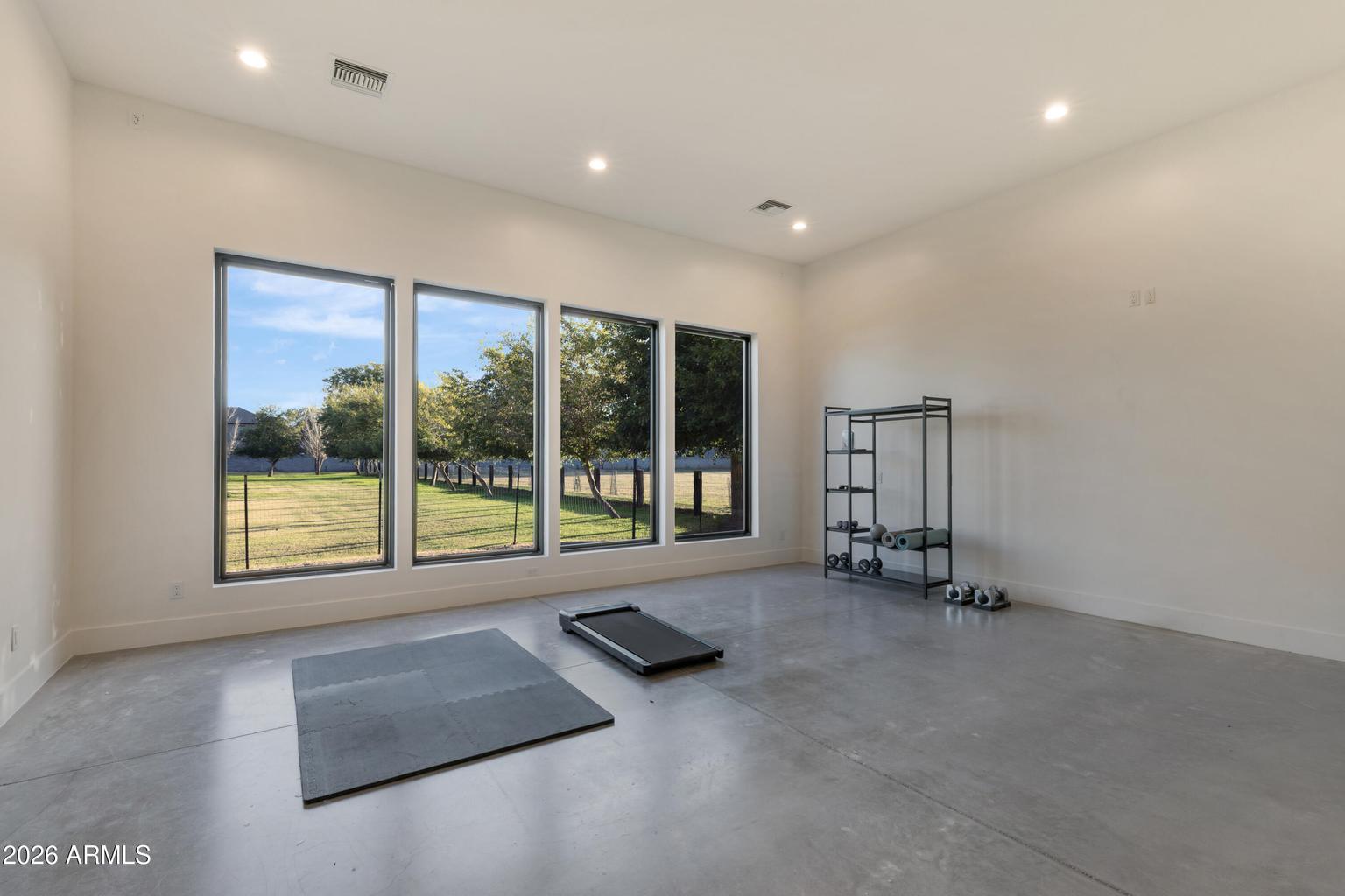 gym with windows and concrete floor 